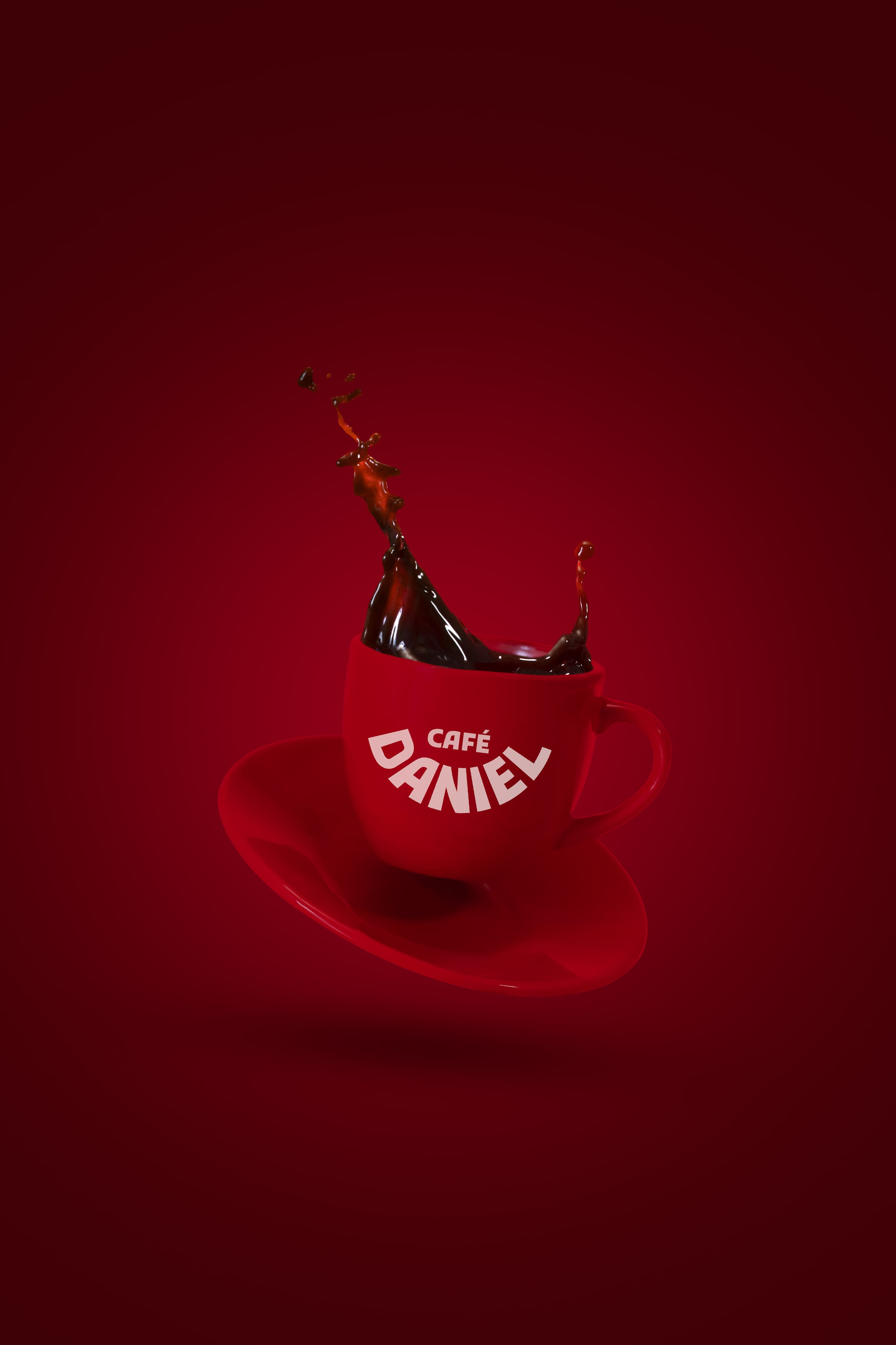 A red Café Daniel espresso cup suspended above its saucer, coffee arcing out of it against a deep red ground